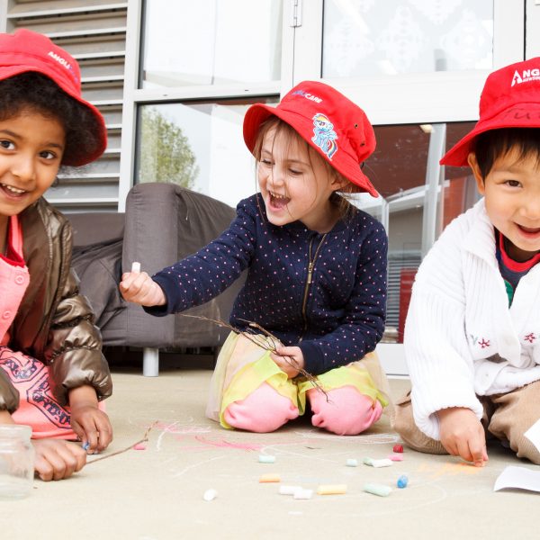 3 preschoolers playing with craft