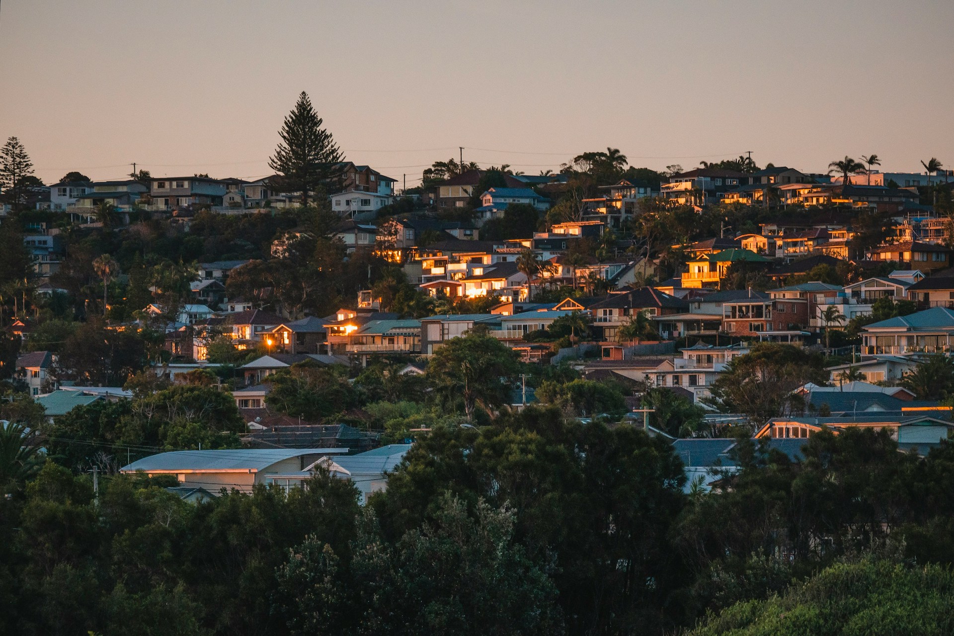 houses grouped together on a hill at evening