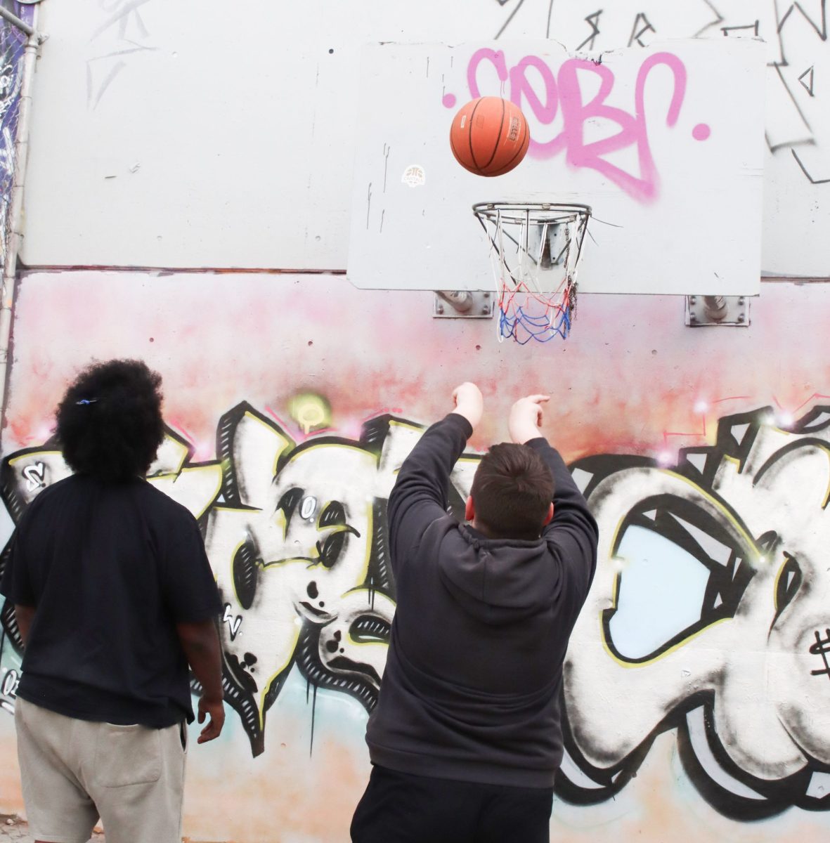 young people accessing Anglicare youth services and playing basketball outside the Junction youth centre