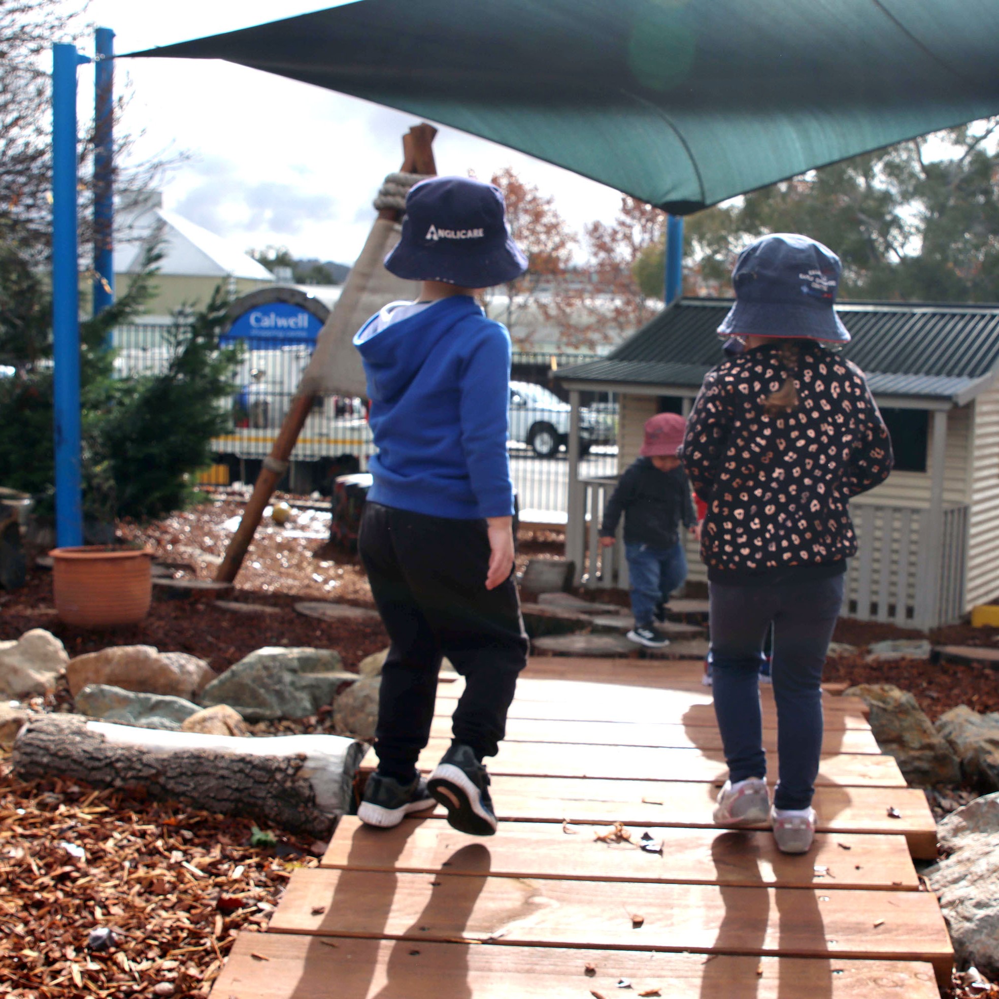 Two young students walking outside at Anglicare's Callwell Early Learning Centre