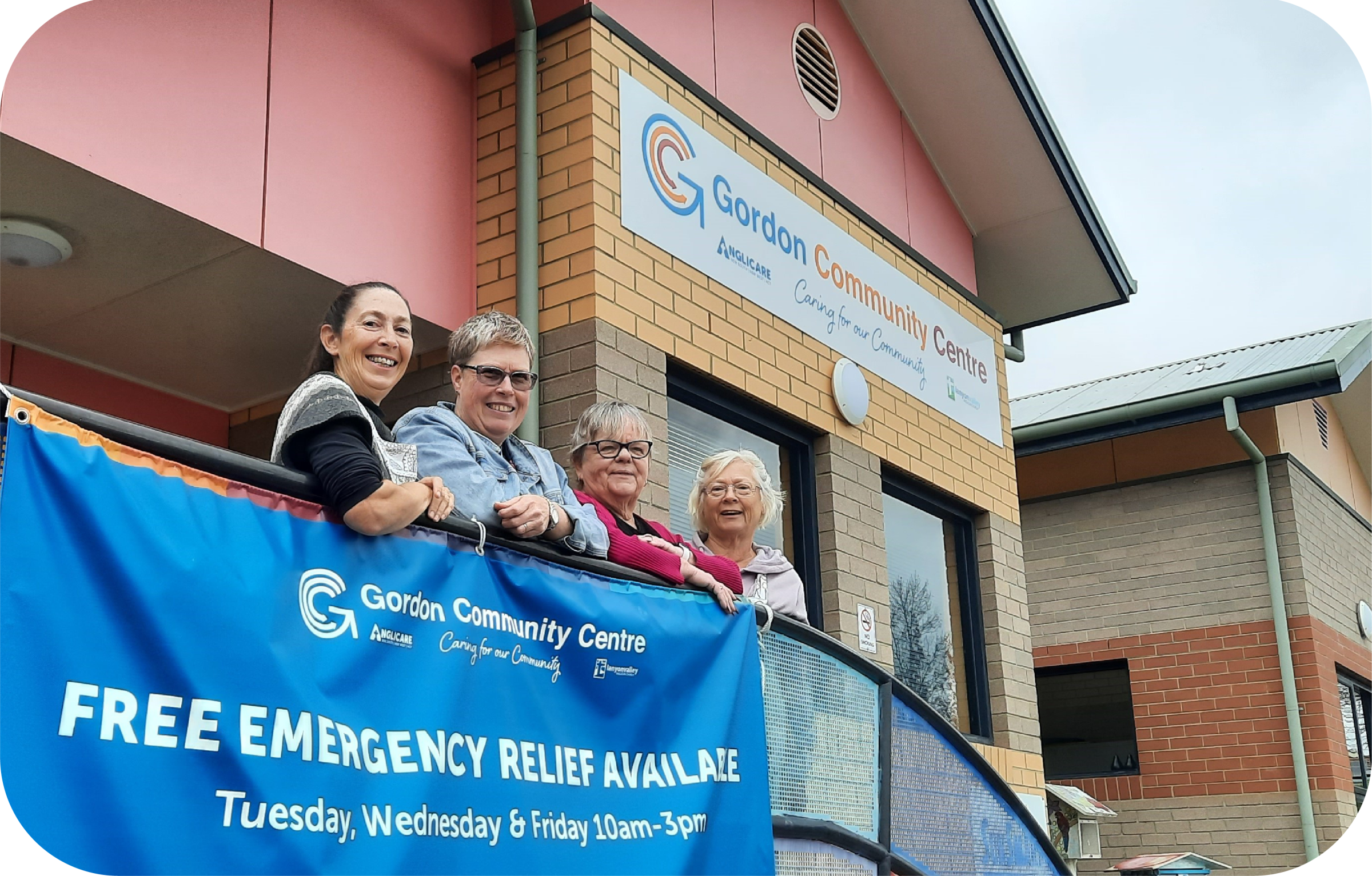 people standing next to a sign for emergency relief