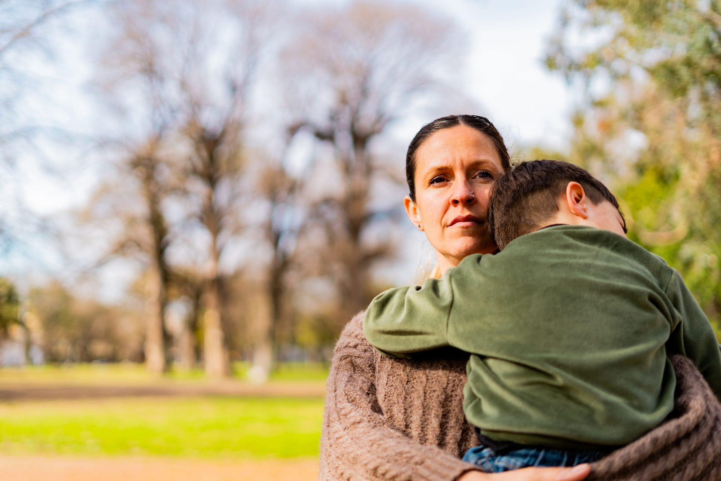 mother holding son and looking worried